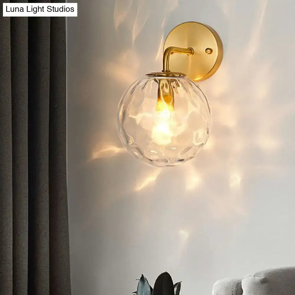 Minimalist gold ball sconce with hammered glass shade bedroom light