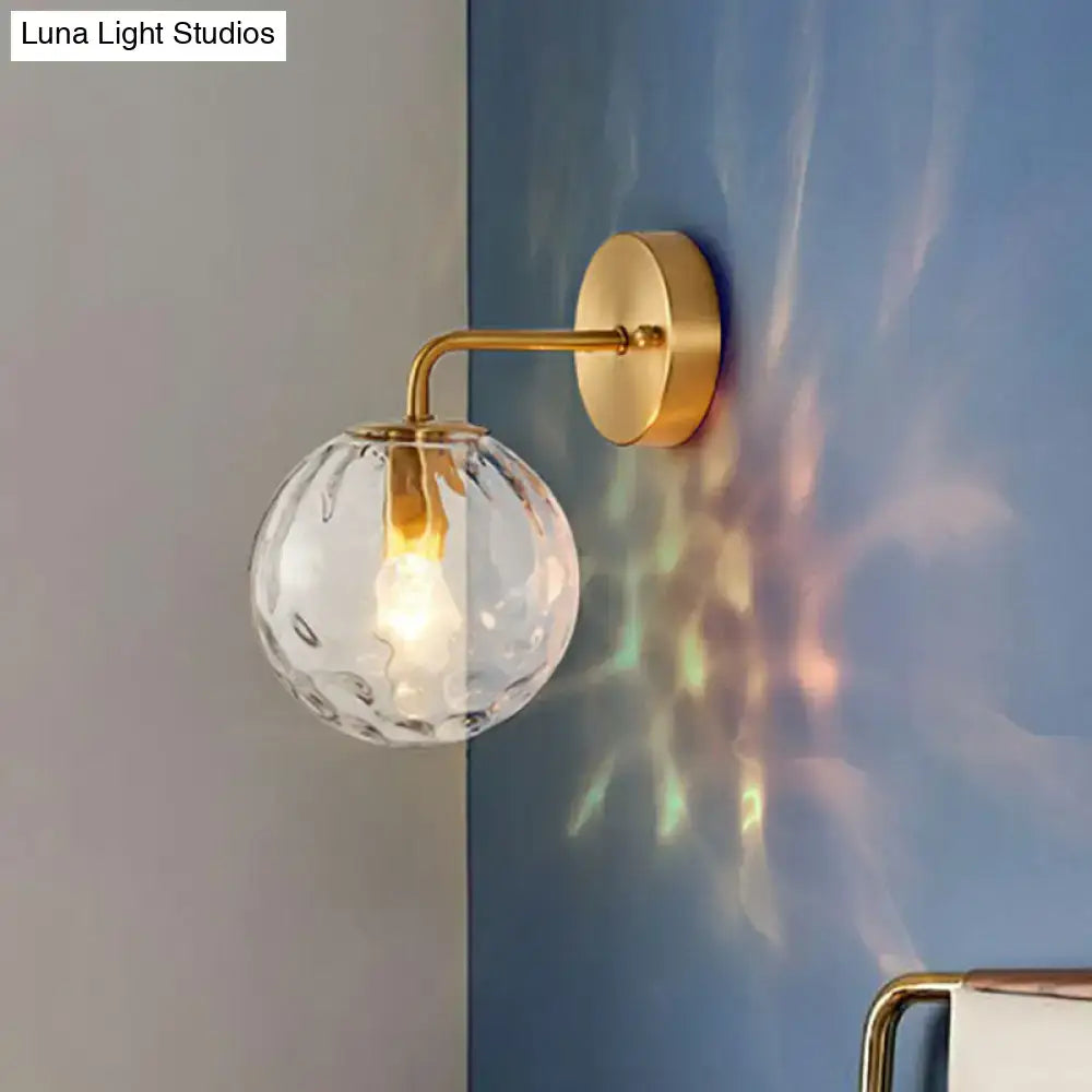 Minimalist gold ball sconce with hammered glass shade bedroom light