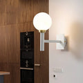 Minimalist white and brass wall lamp with opal glass shade bedroom