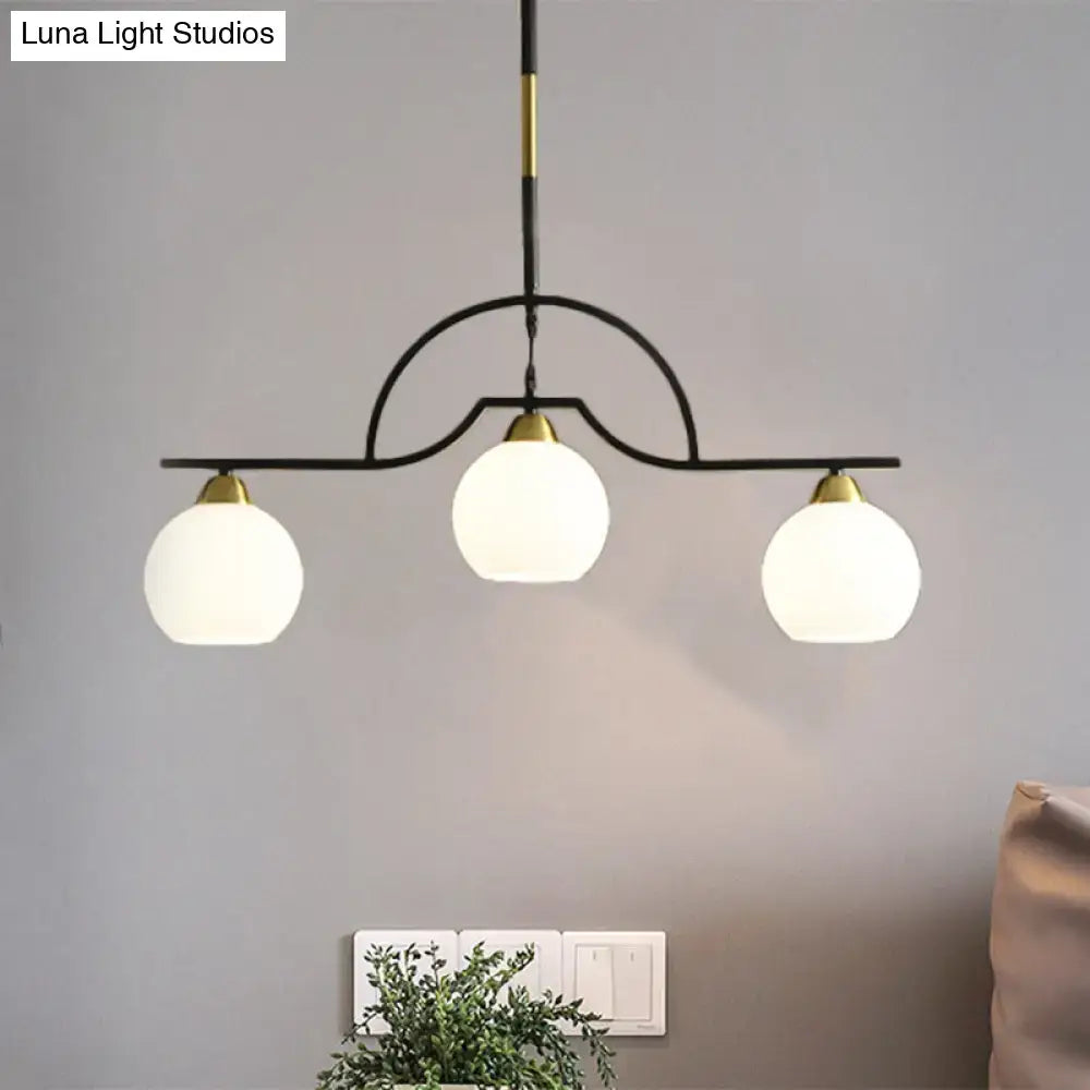 Modern black and brass pendant light with clear glass – kitchen island