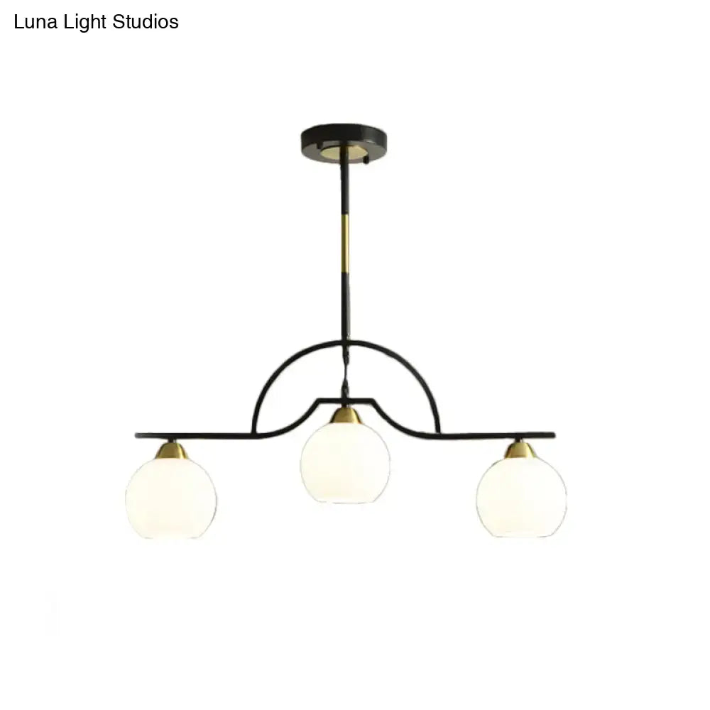 Modern black and brass pendant light with clear glass – kitchen island