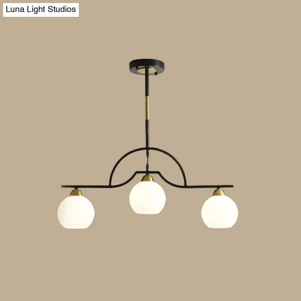 Modern black and brass pendant light with clear glass – kitchen island