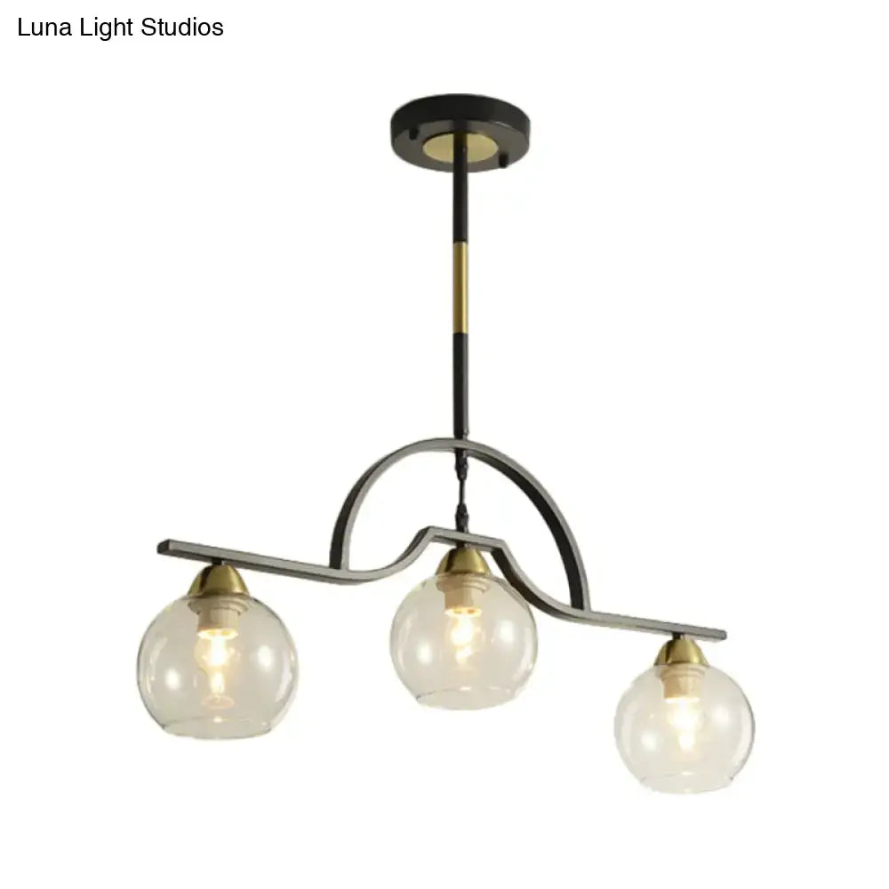 Modern black and brass pendant light with clear glass – kitchen island