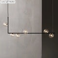 Modern black linear island pendant with glass shade dining room