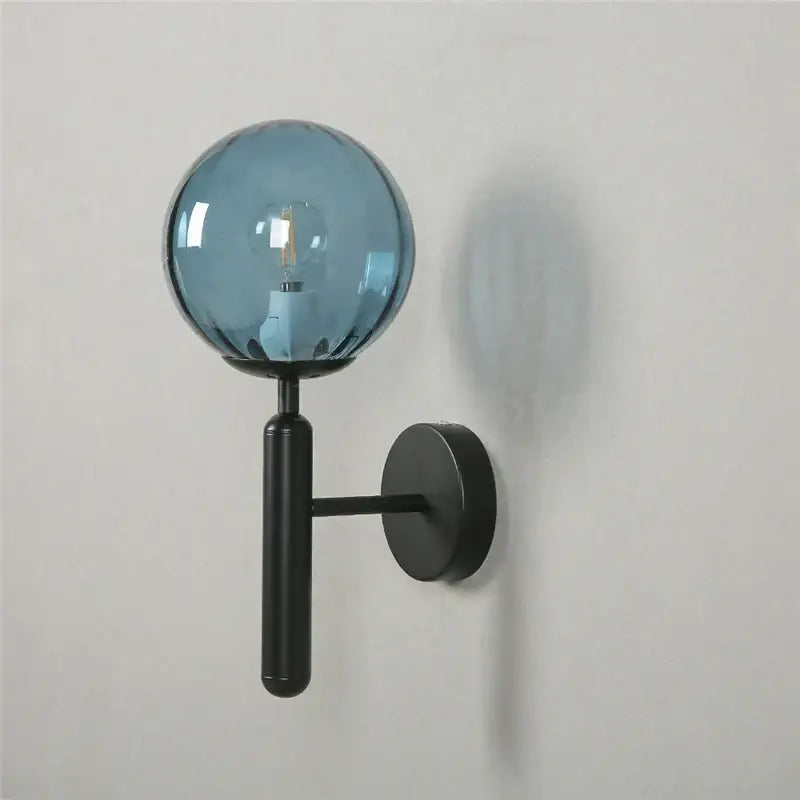 Modern brass and pink glass wall sconce for bedroom