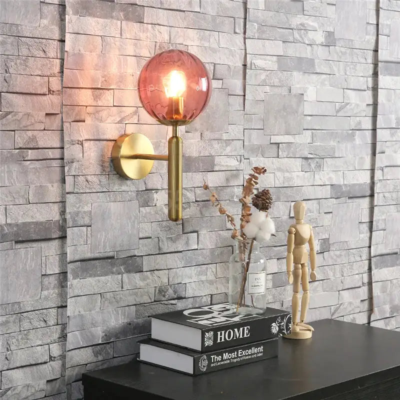 Modern brass and pink glass wall sconce for bedroom