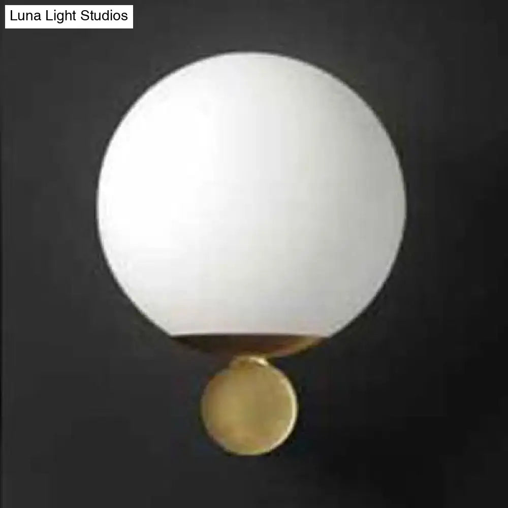 Modern brass and white glass sphere wall sconce bedroom light