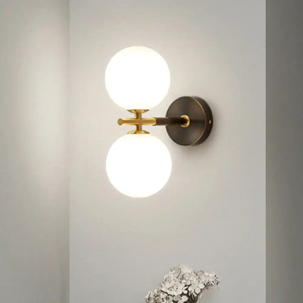 Modern brass and white glass wall sconce – bedroom globe light