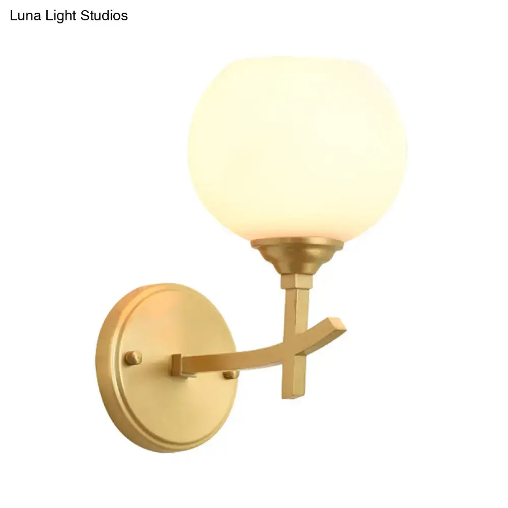 Modern brass armed sconce with opal glass shade bedroom wall lamp