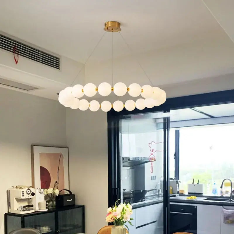 Modern brass led pendant light with frosted spheres for living room