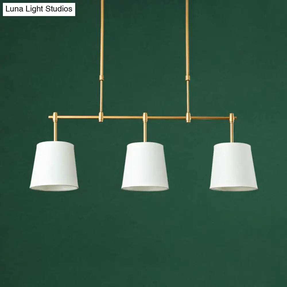 Modern brass pendant light with white green flaxen shades dining room