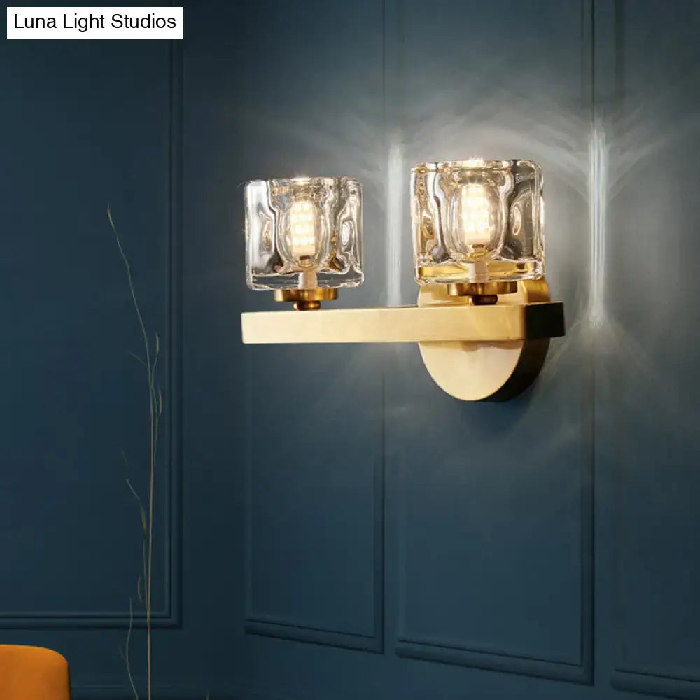 Modern brass wall light with clear crystal block for living room