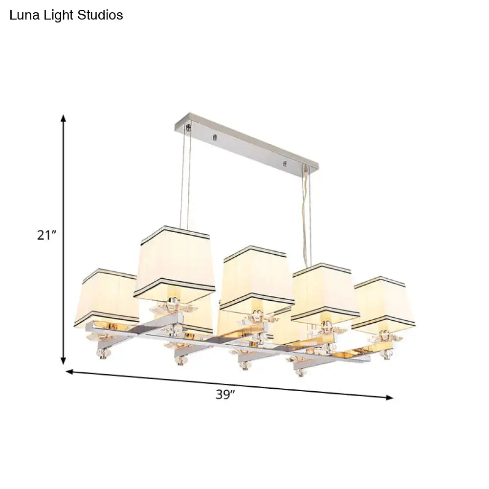 Modern chrome island pendant light with cream shades for dining rooms