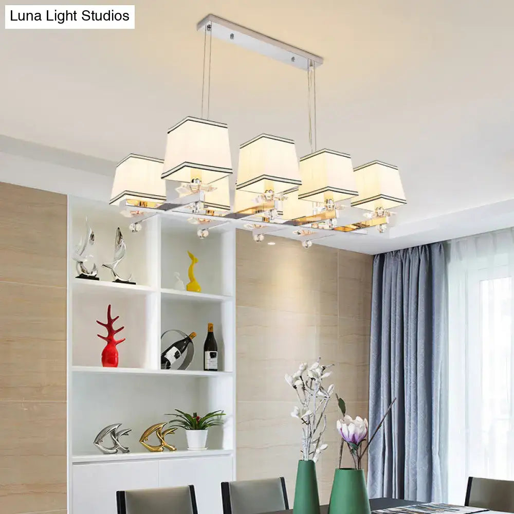 Modern chrome island pendant light with cream shades for dining rooms