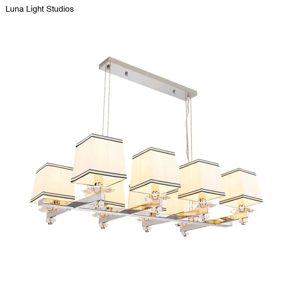 Modern chrome island pendant light with cream shades for dining rooms