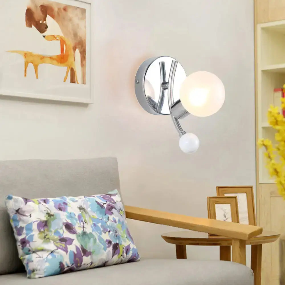 Modern chrome sconce with dual globe glass shades for living room