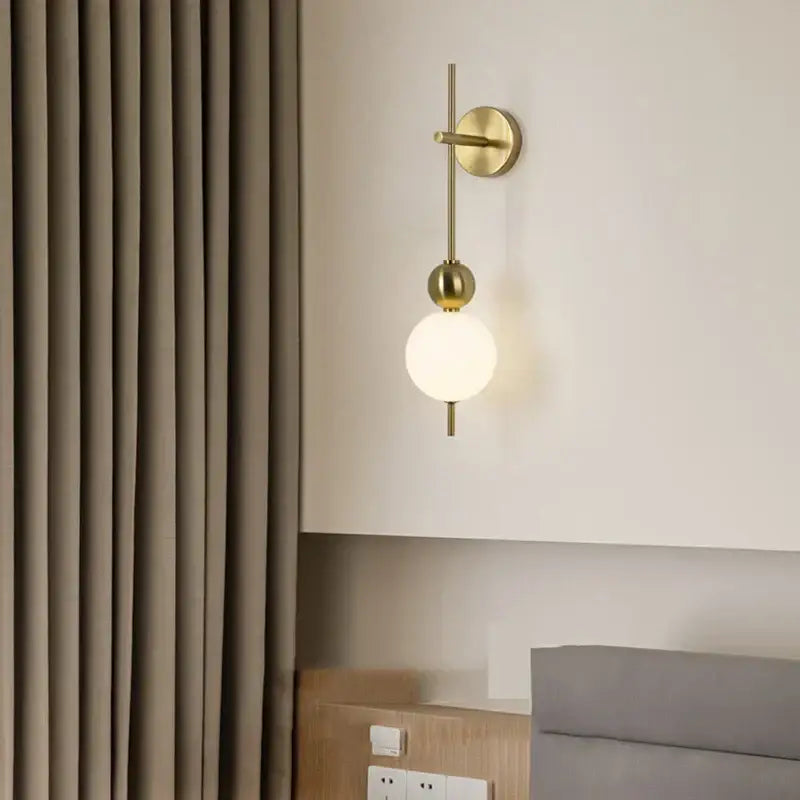 Modern gold led wall sconce with frosted glass spheres for bedroom