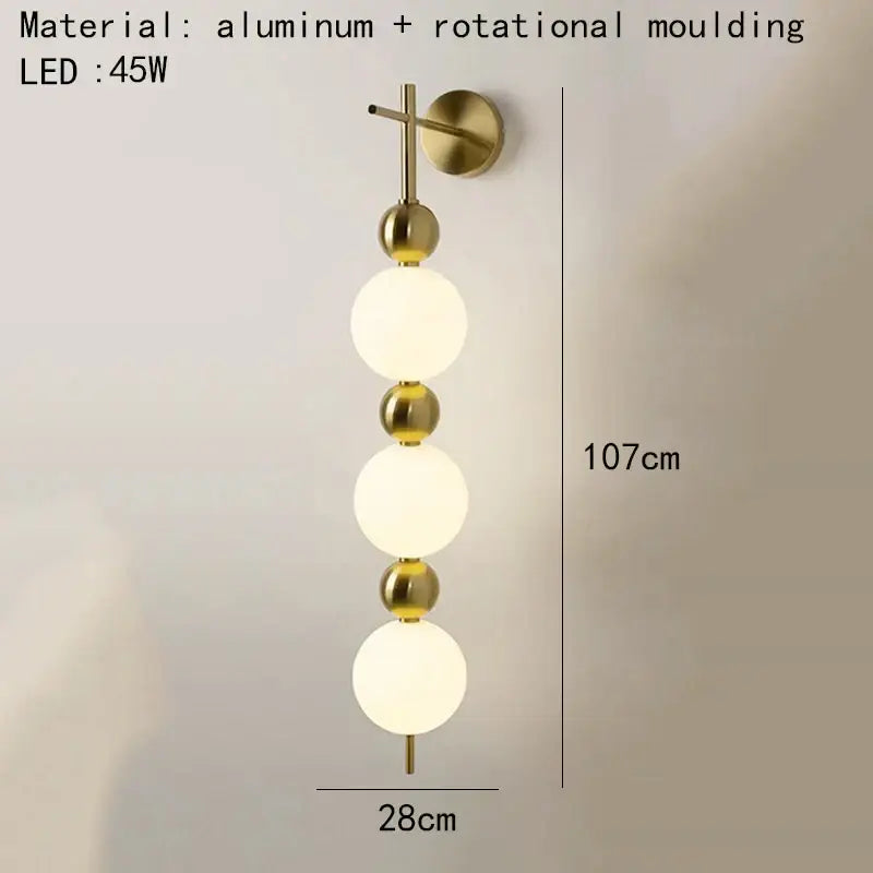Modern gold led wall sconce with frosted glass spheres for bedroom