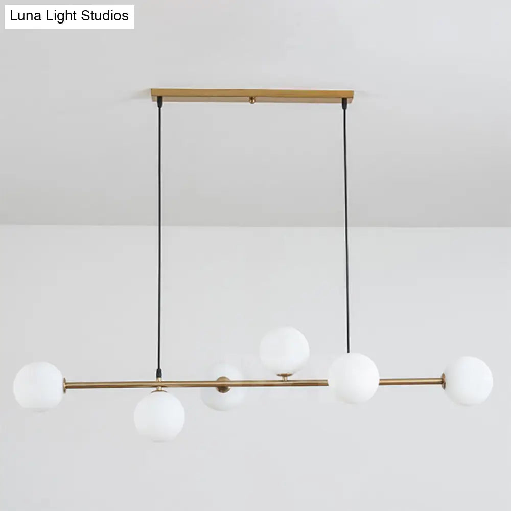 Modern gold metal island pendant with blue glass spheres dining room