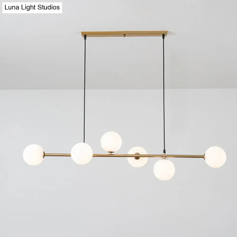 Modern gold metal island pendant with blue glass spheres dining room