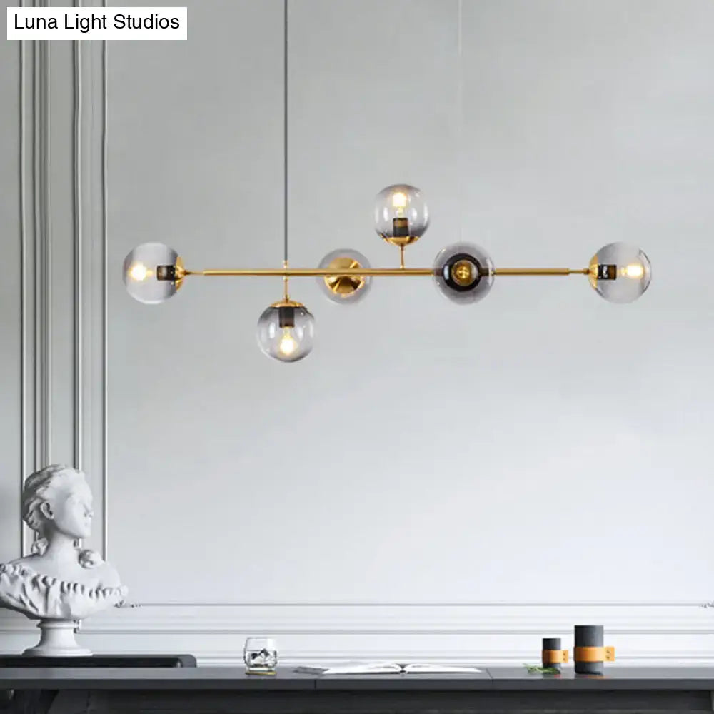 Modern gold metal island pendant with blue glass spheres dining room