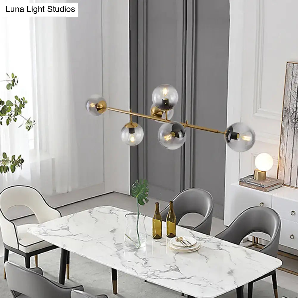 Modern gold metal island pendant with blue glass spheres dining room