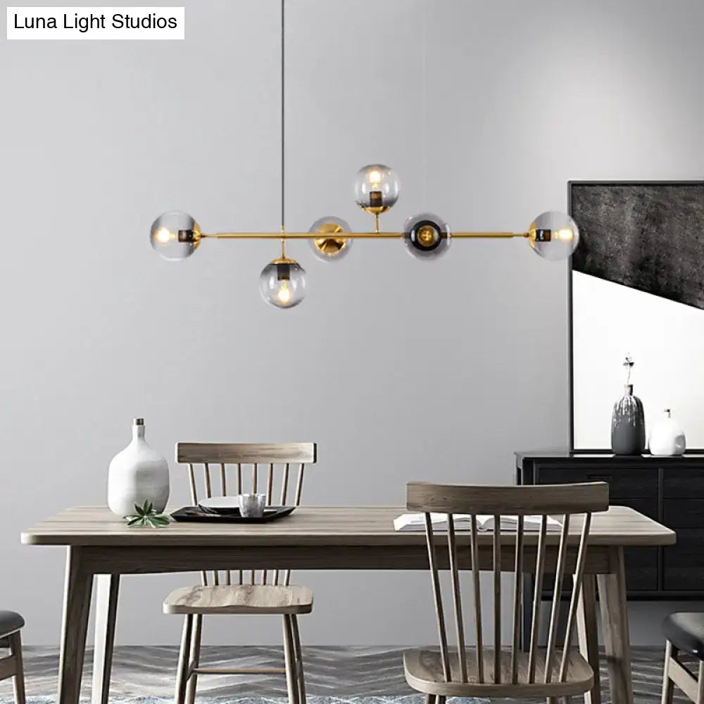 Modern gold metal island pendant with blue glass spheres dining room