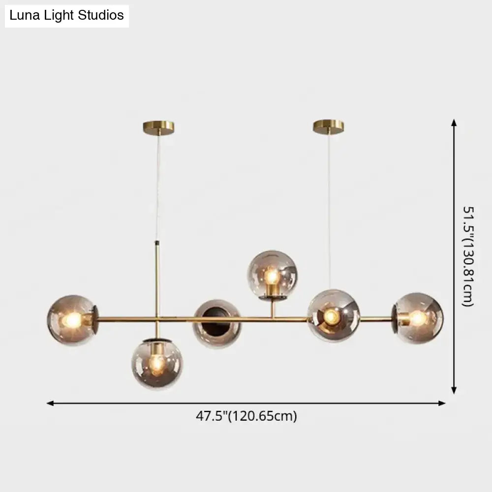 Modern gold metal island pendant with blue glass spheres dining room