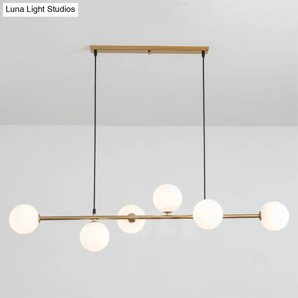 Modern gold metal island pendant with blue glass spheres dining room