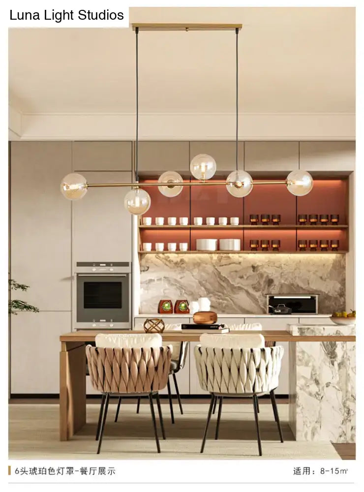 Modern gold metal island pendant with blue glass spheres dining room