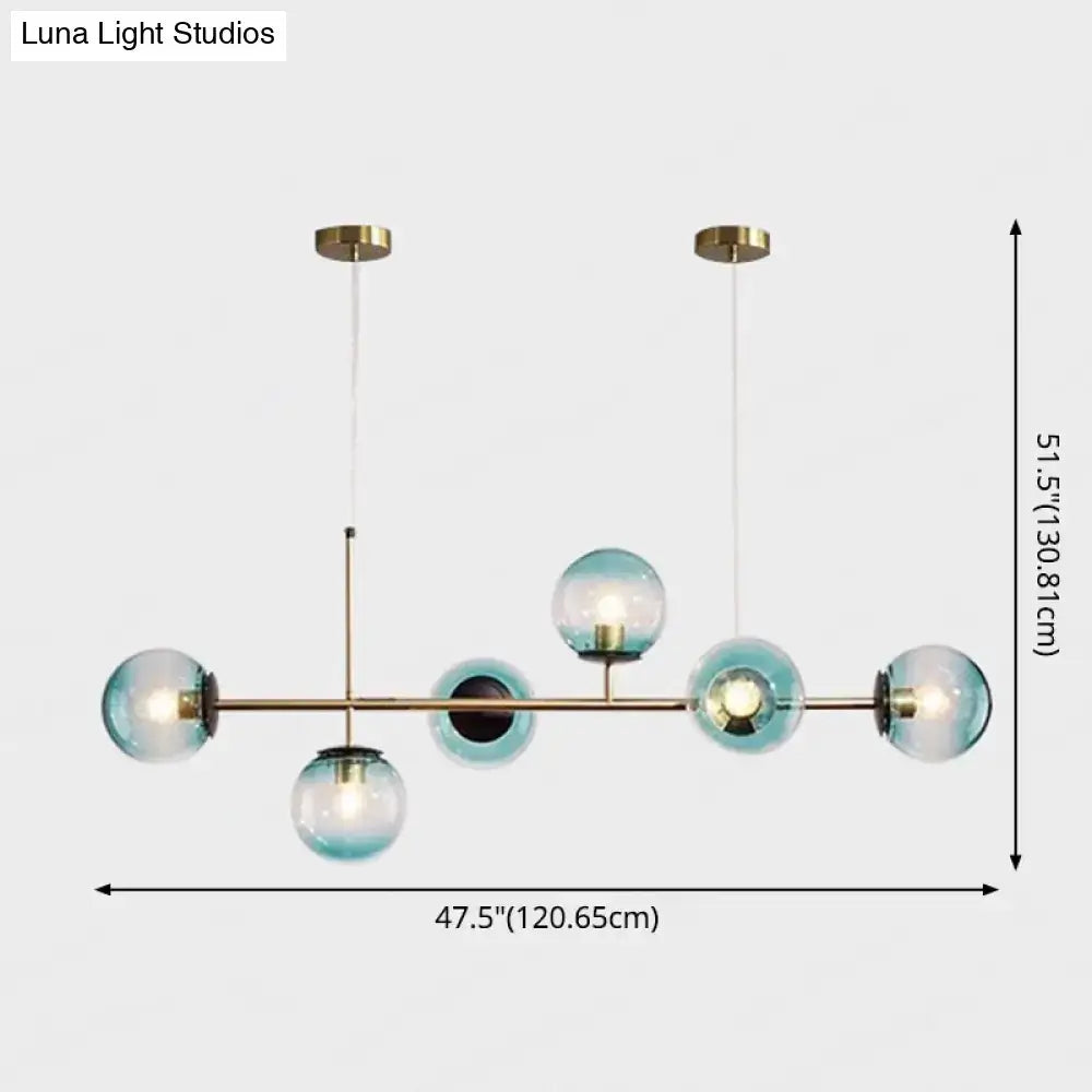 Modern gold metal island pendant with blue glass spheres dining room