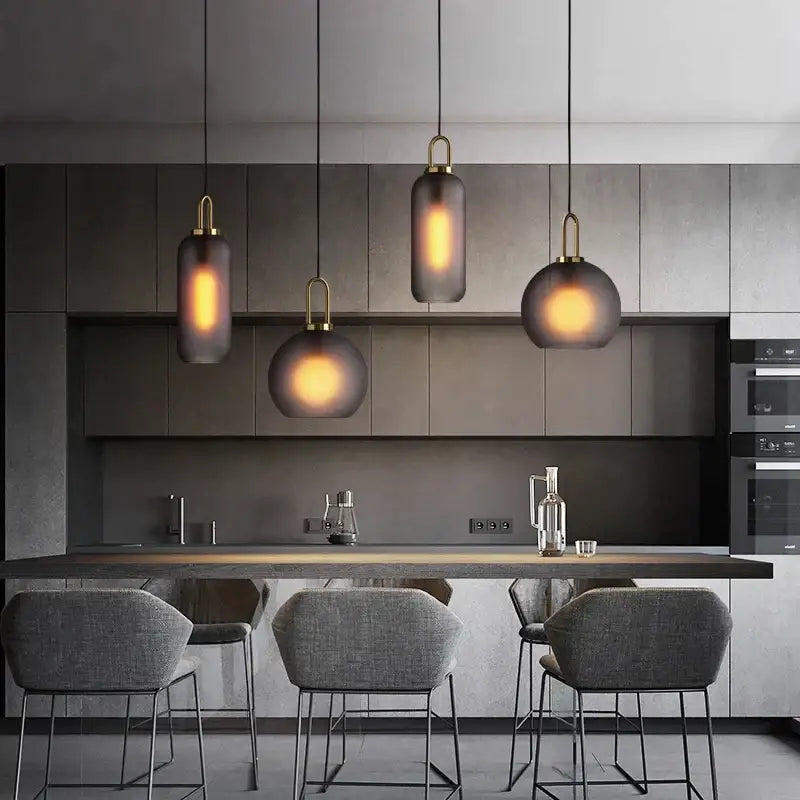 Modern gray glass ball pendant lights – dining room brass accents