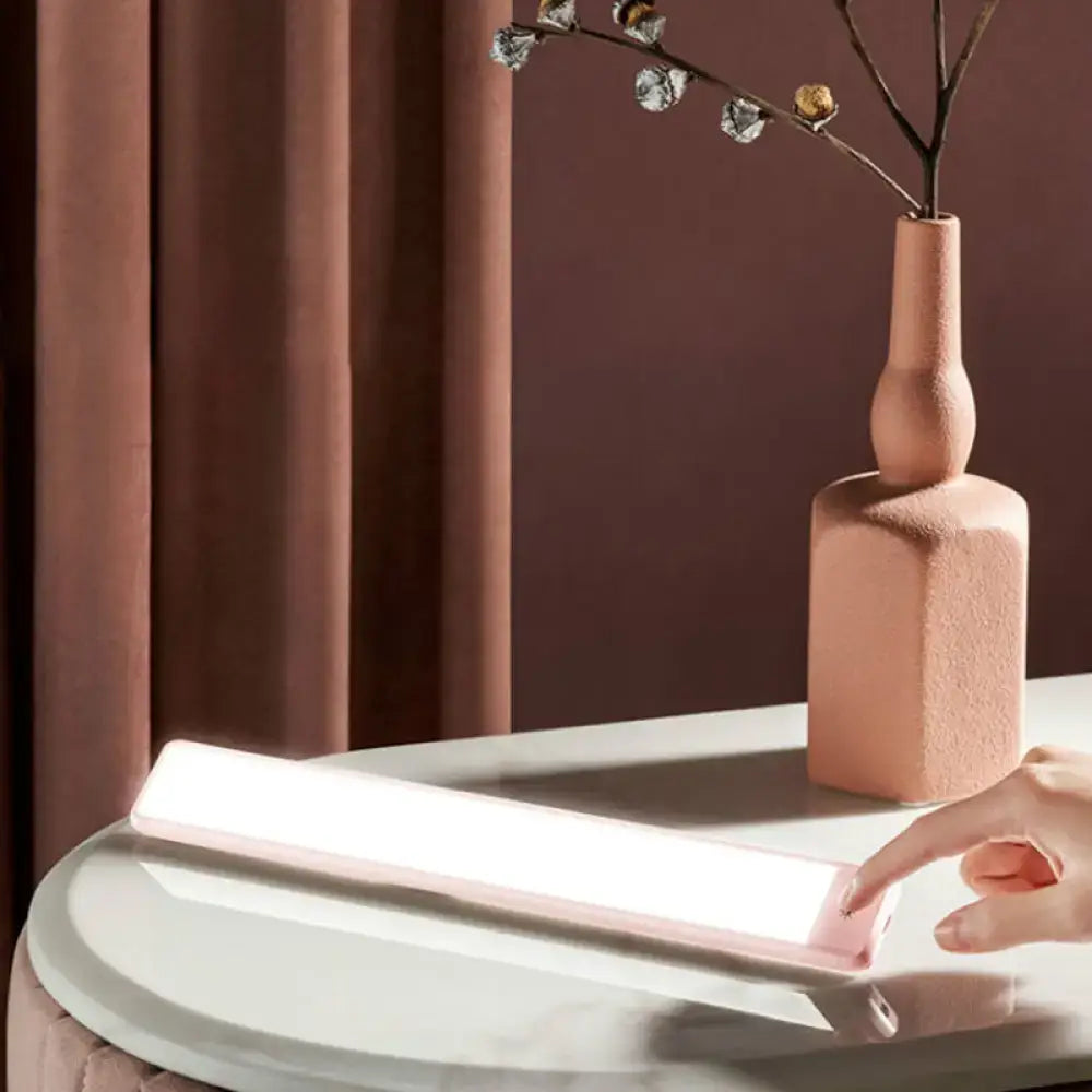 Modern pink elongated vanity lighting fixture for bedroom