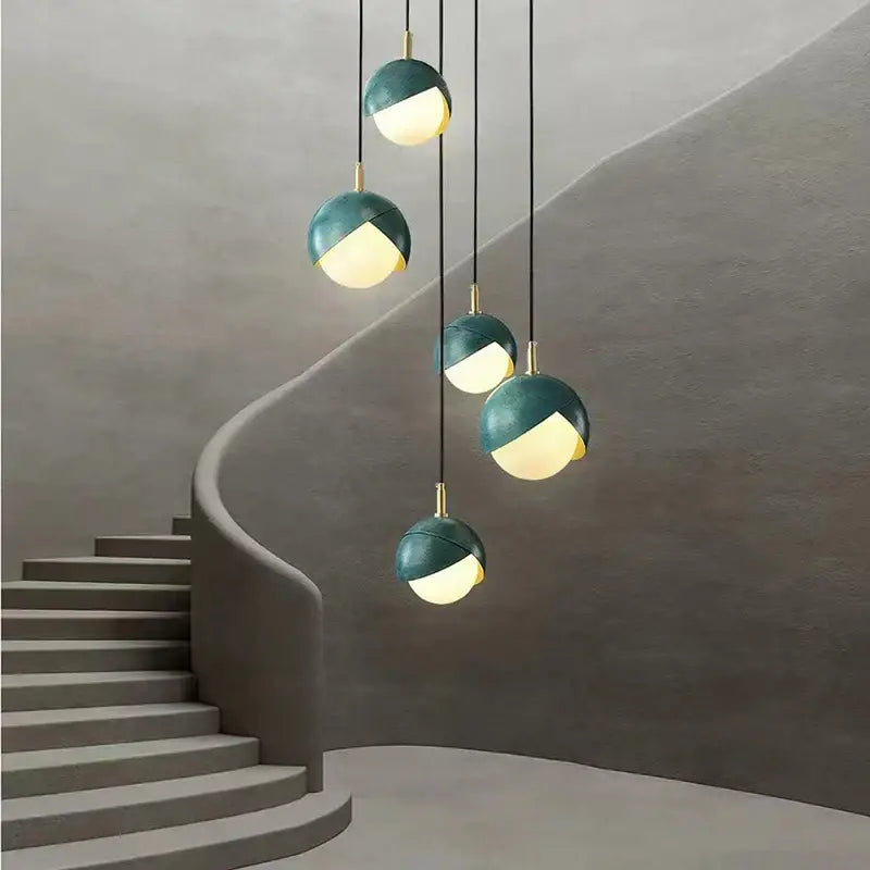 Modern teal glass and brass pendant light for kitchen island