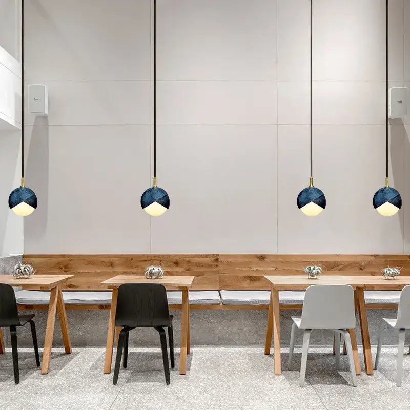 Modern teal glass and brass pendant light for kitchen island