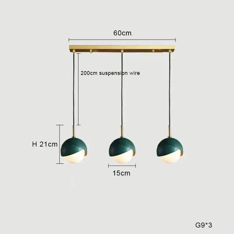 Modern teal glass and brass pendant light for kitchen island