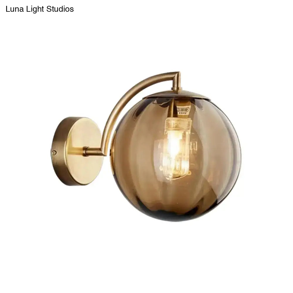 Postmodern brass armed ball sconce – bedroom amber glass wall light