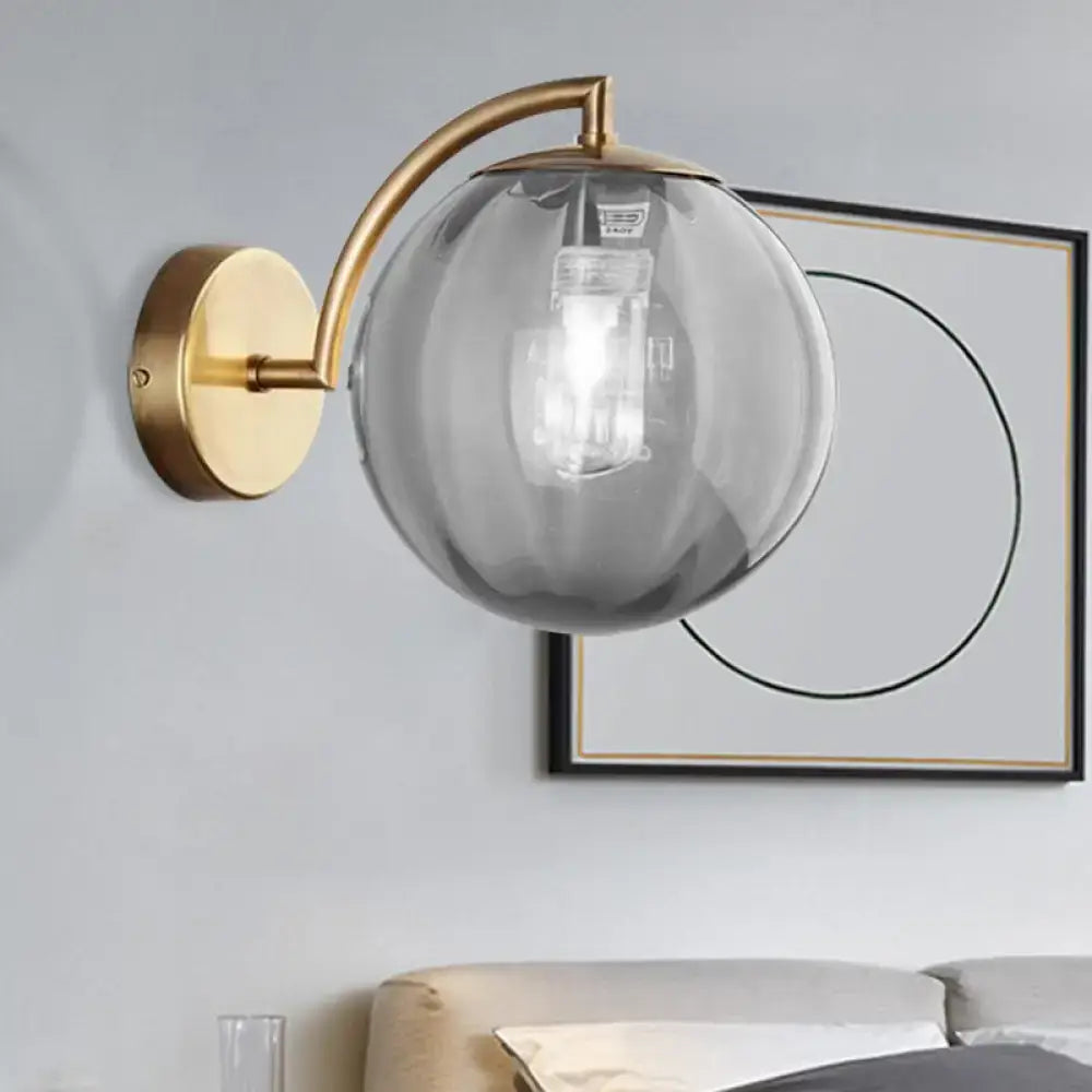 Postmodern brass armed ball sconce – bedroom amber glass wall light