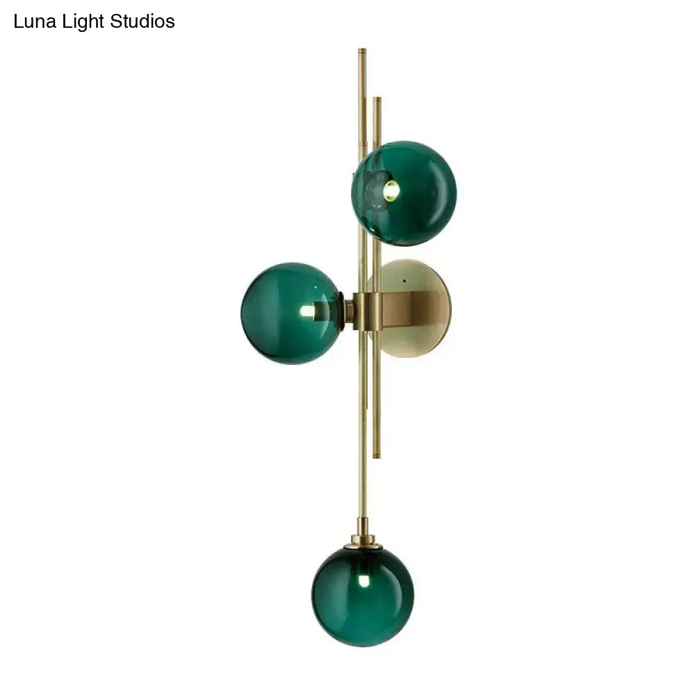 Retro brass wall sconce with 3 glass globes for dining room