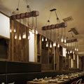 DecorBites™ 10-Head Metal Pendant Lamp with Exposed Bulbs and Wood Beam in Brown Finish