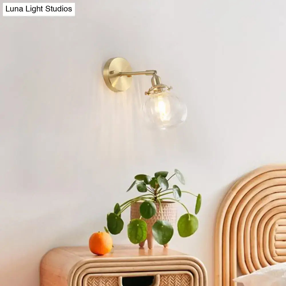 Vintage brass wall light with champagne & clear glass shade bedroom