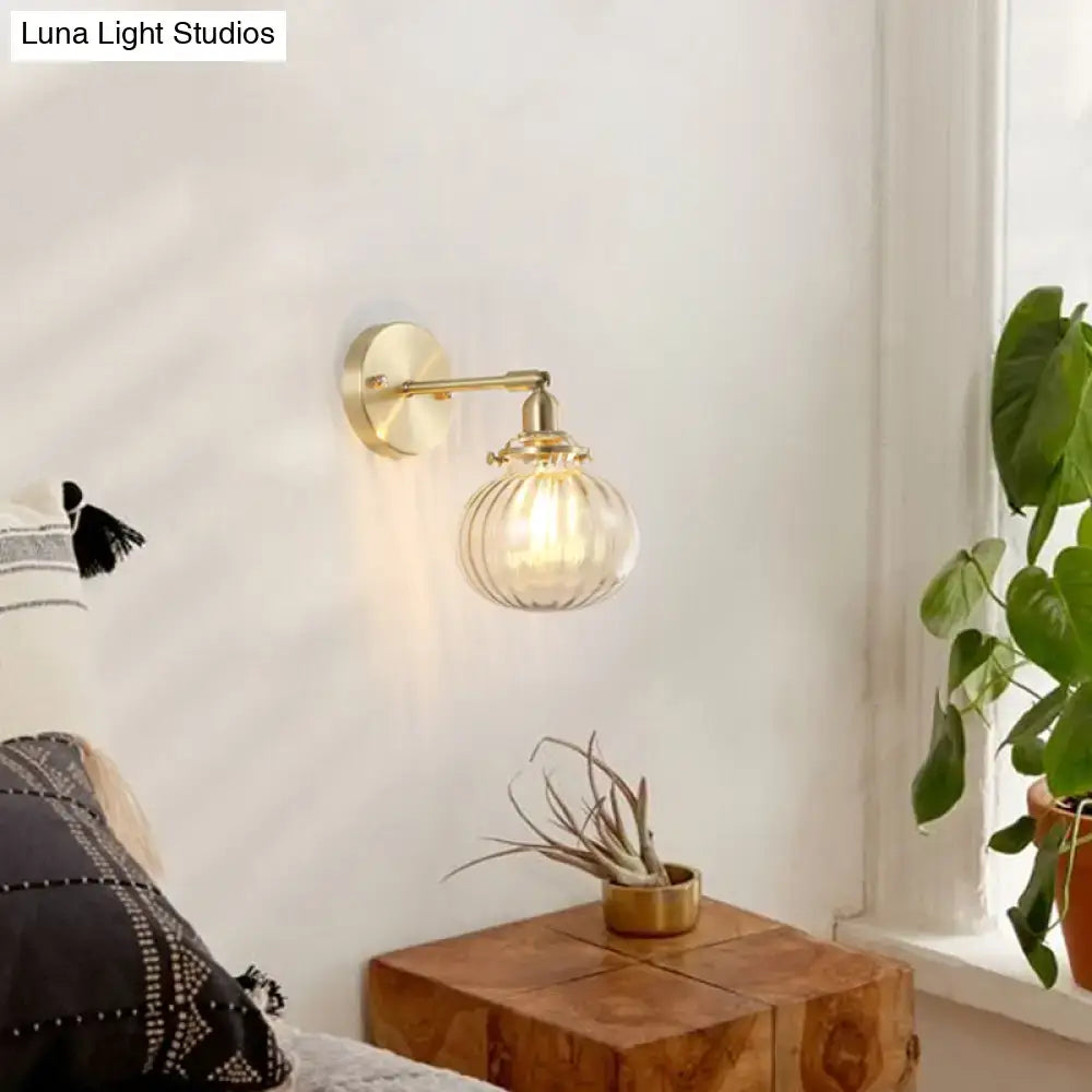 Vintage brass wall light with champagne & clear glass shade bedroom