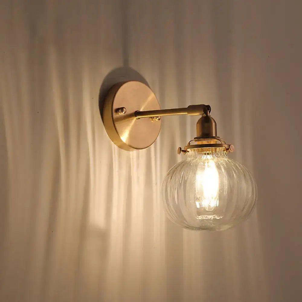 Vintage brass wall light with champagne & clear glass shade bedroom