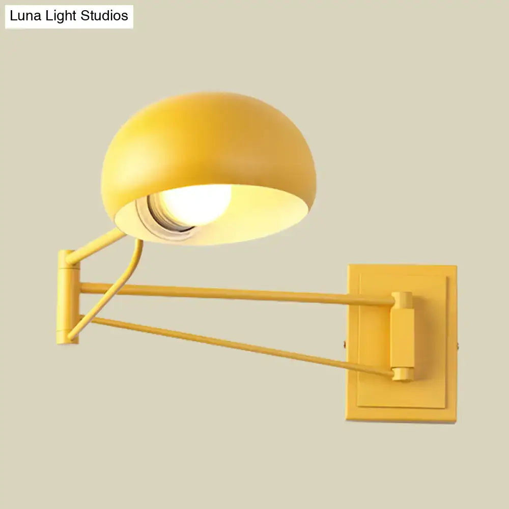 Yellow adjustable metal wall sconce with bowl shade for bedroom