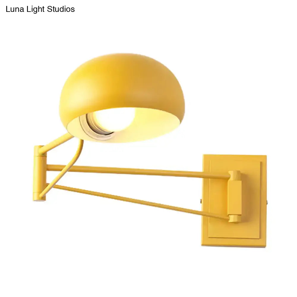 Yellow adjustable metal wall sconce with bowl shade for bedroom